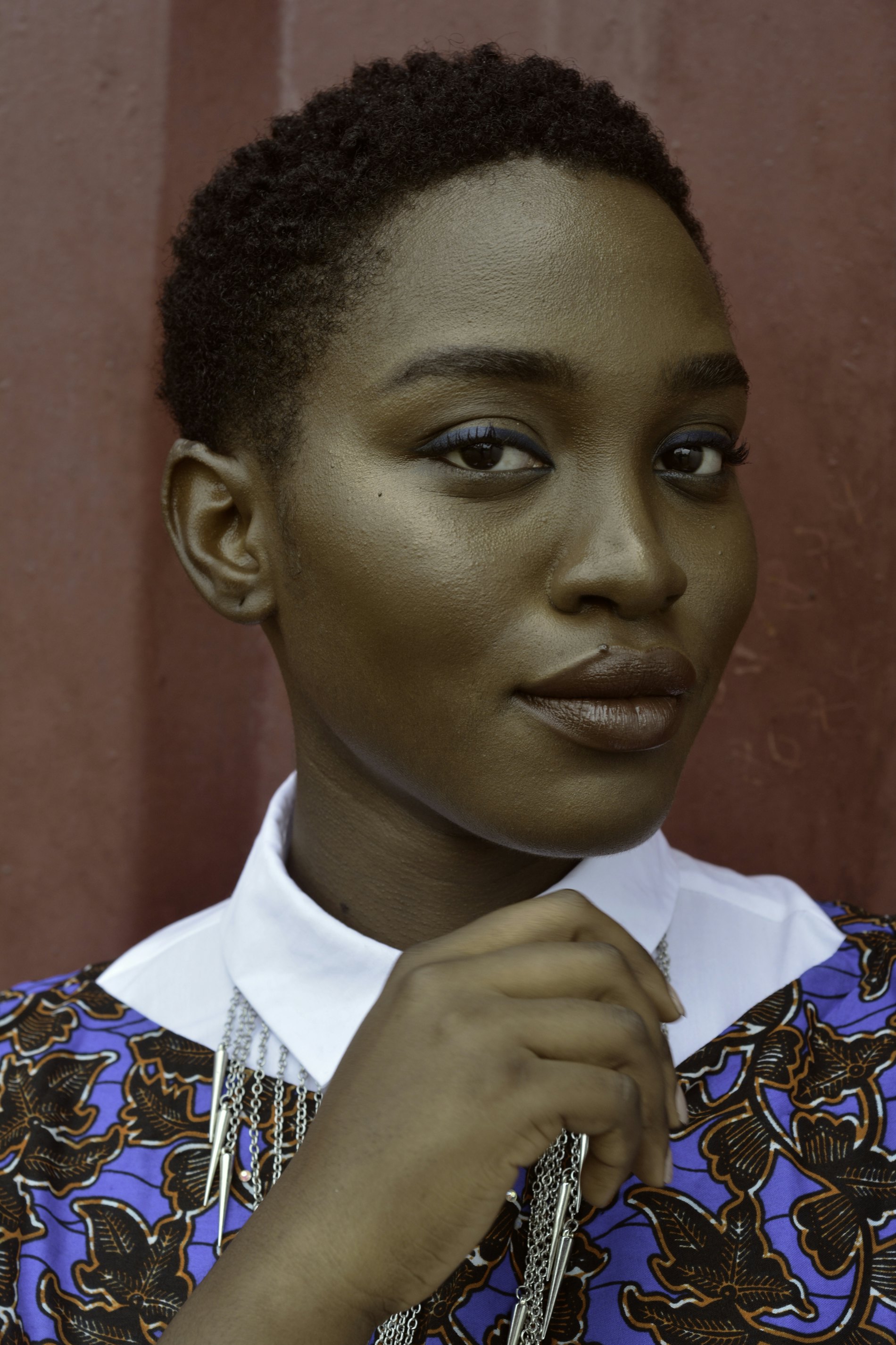 A young woman in soft light, looking directly ahead